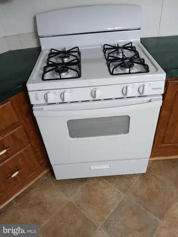 a close view of a stove a microwave and door