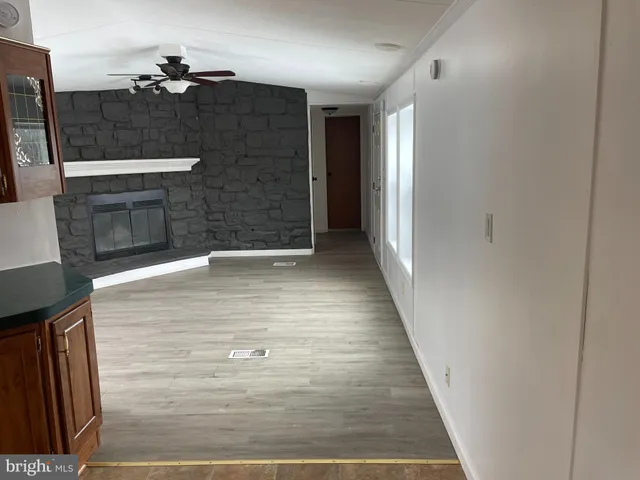 a view of a hallway with front door and wooden floor