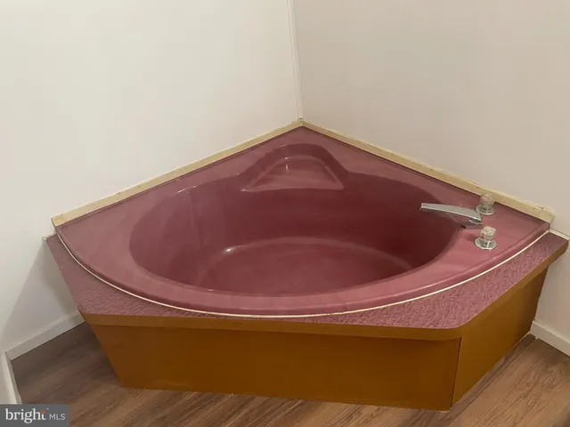 a bath tub sitting in a small bathroom