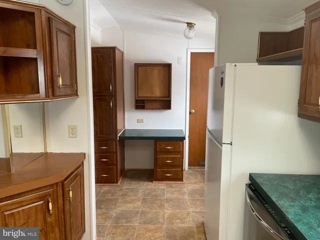 a kitchen with stainless steel appliances granite countertop a refrigerator and a stove