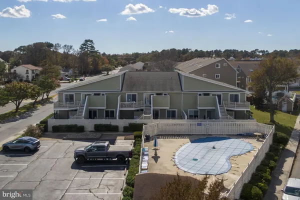 a front view of a house with cars parked