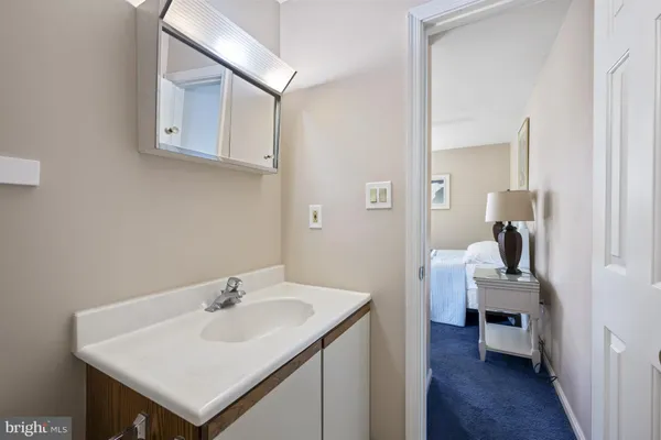 a en suite bathroom with a sink and a mirror