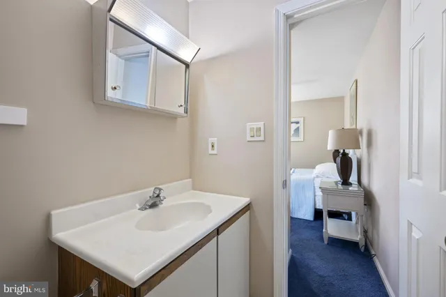 a en suite bathroom with a sink and a mirror