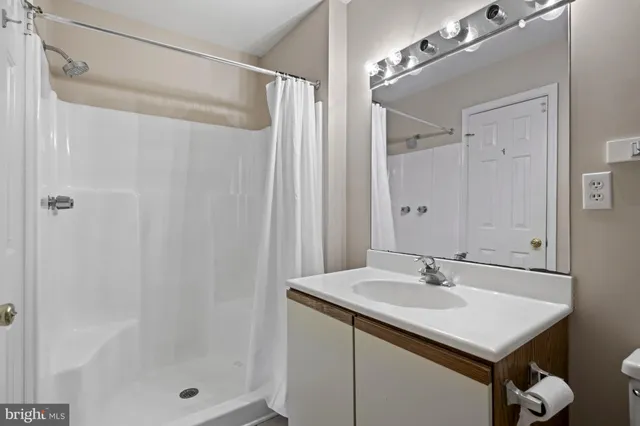 a bathroom with a sink a shower and a mirror