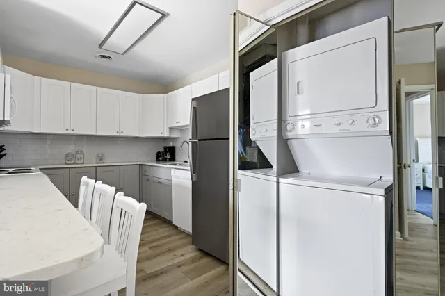 a kitchen with stainless steel appliances a refrigerator sink and cabinets