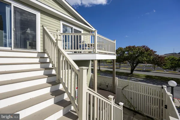 a view of a house with wooden deck