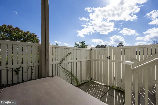 a view of a balcony with wooden fence