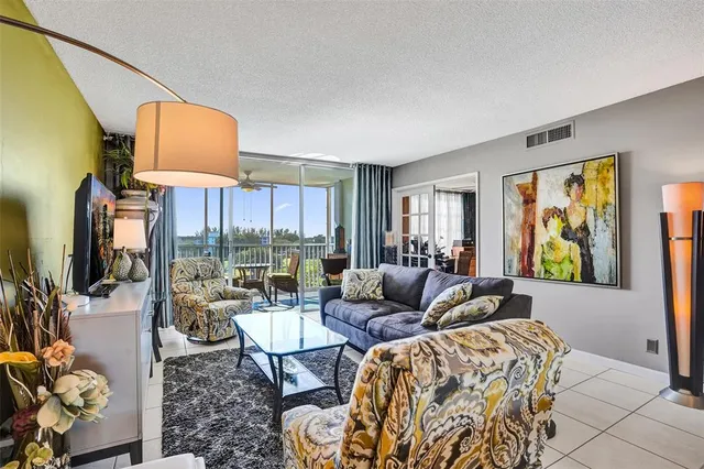 a living room with furniture large window and flat screen tv