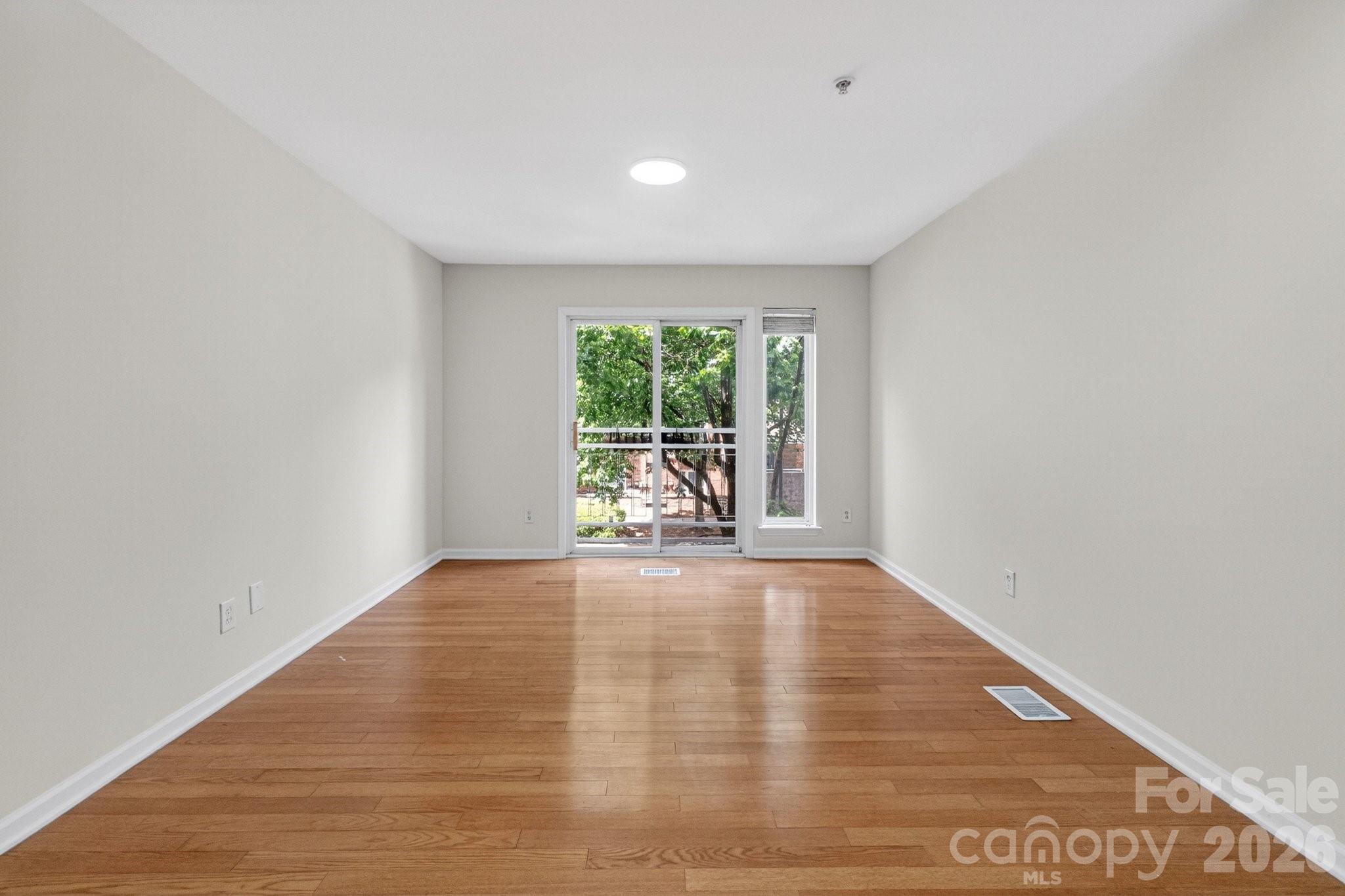 639 Raphael Place Charlotte, NC 28205 - Photo 12 of 36 a view of an empty room with wooden floor and a window