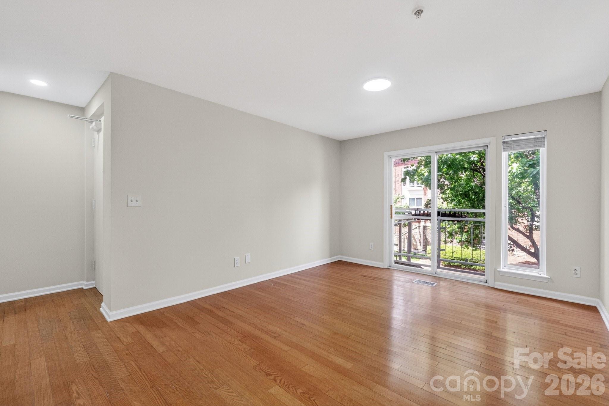 639 Raphael Place Charlotte, NC 28205 - Photo 13 of 36 a view of an empty room with wooden floor and a window