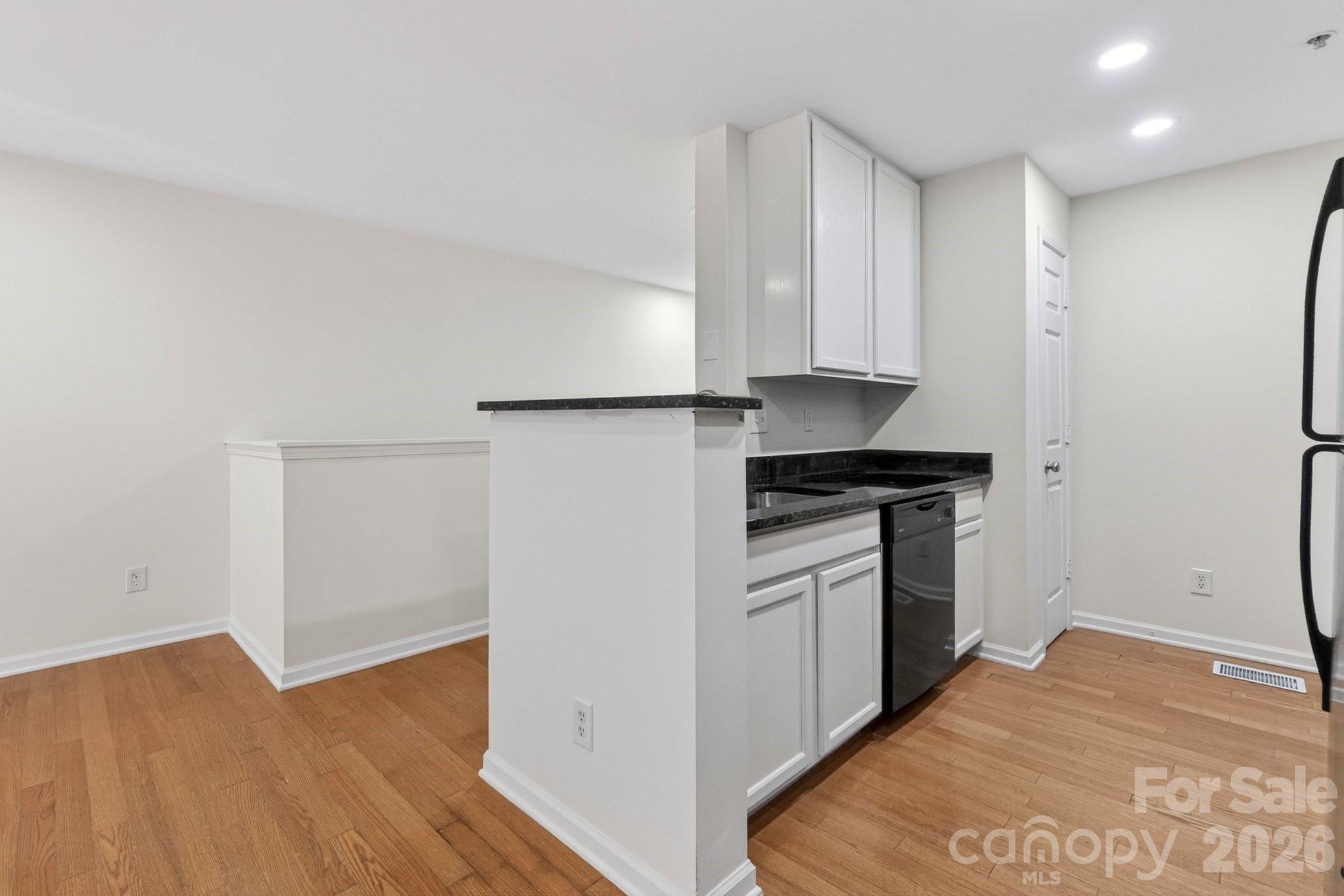 639 Raphael Place Charlotte, NC 28205 - Photo 5 of 36 a kitchen with a refrigerator and a stove top oven