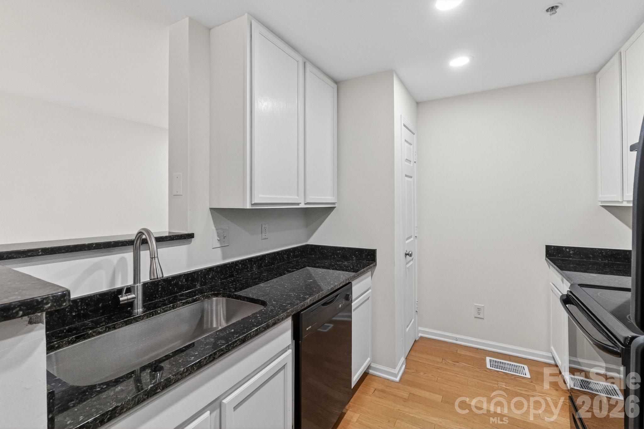 639 Raphael Place Charlotte, NC 28205 - Photo 6 of 36 a kitchen that has a sink and a stove