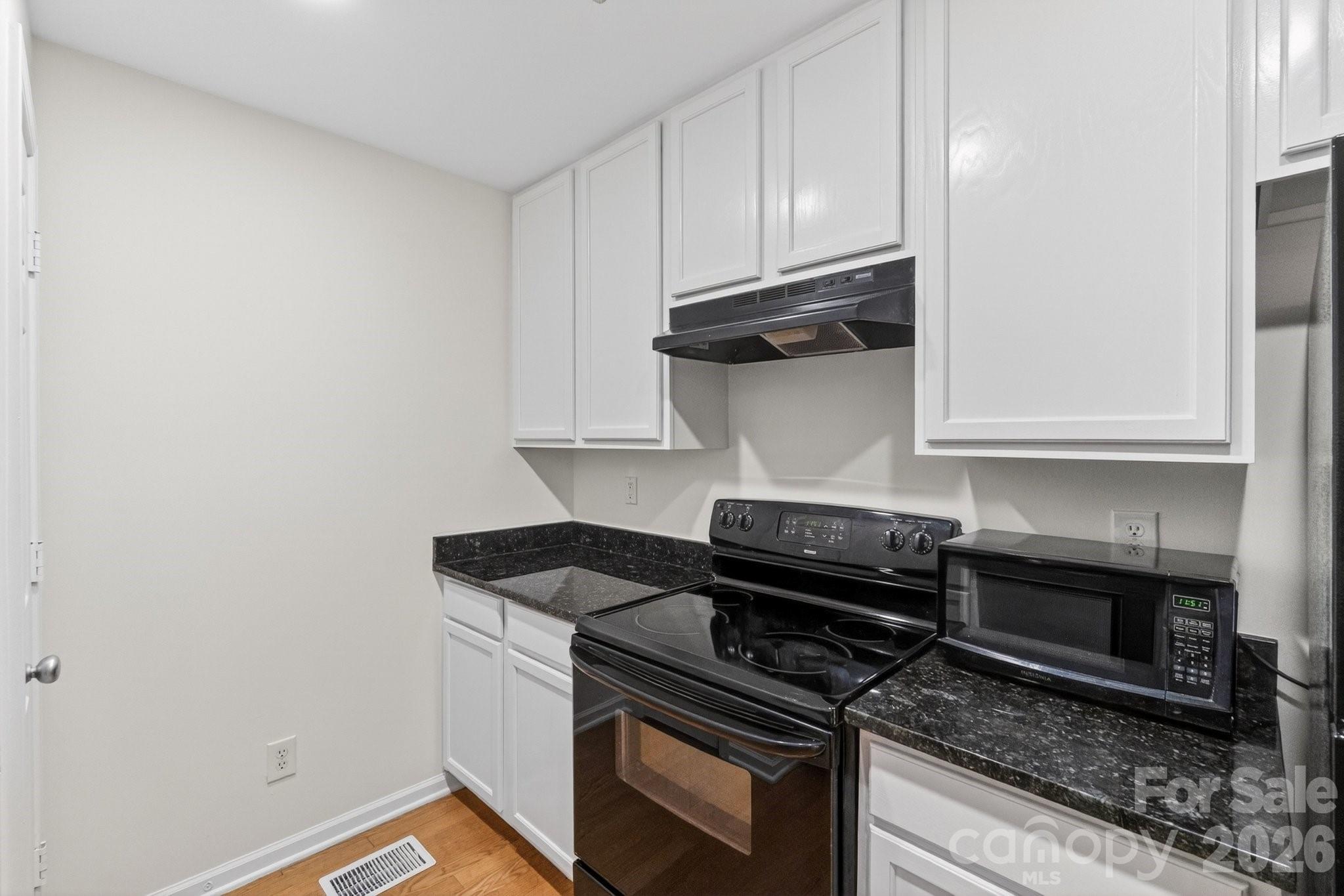 639 Raphael Place Charlotte, NC 28205 - Photo 8 of 36 a kitchen with a stove and a microwave