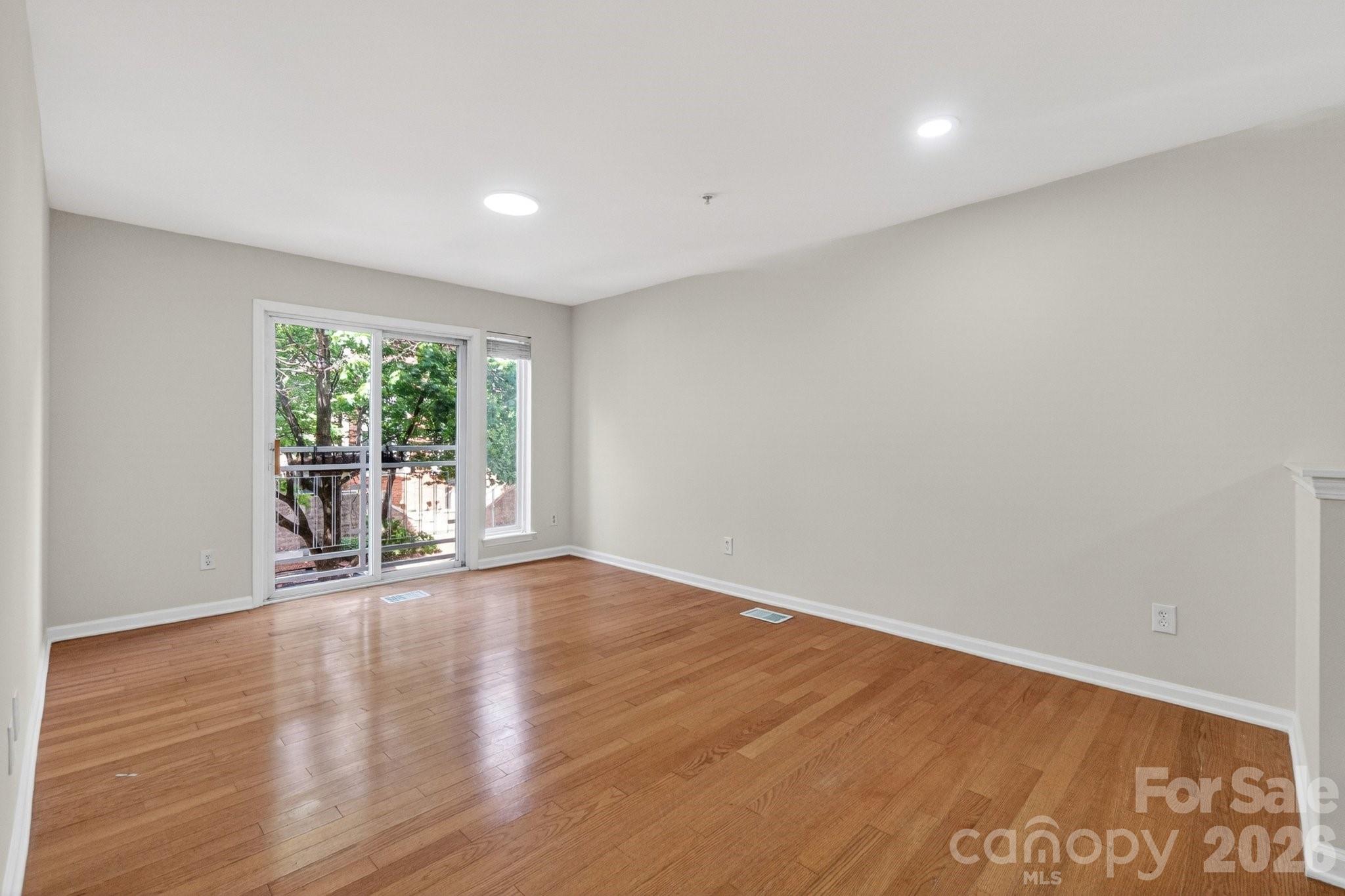 639 Raphael Place Charlotte, NC 28205 - Photo 10 of 36 a view of an empty room with wooden floor and a window
