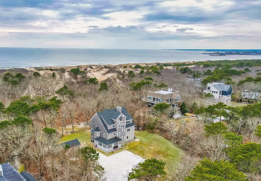 an aerial view of a house with beach