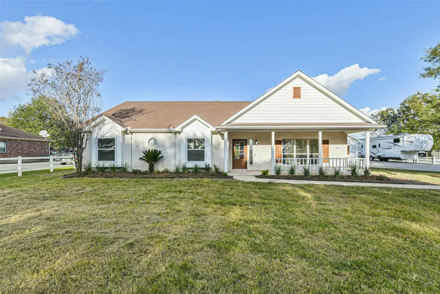 a front view of a house with a garden