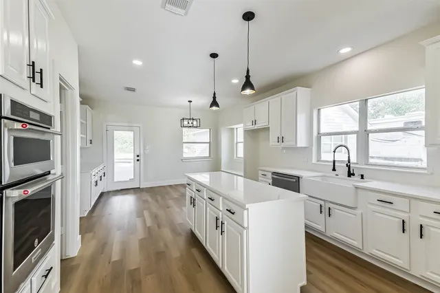 a kitchen with a sink stove and refrigerator