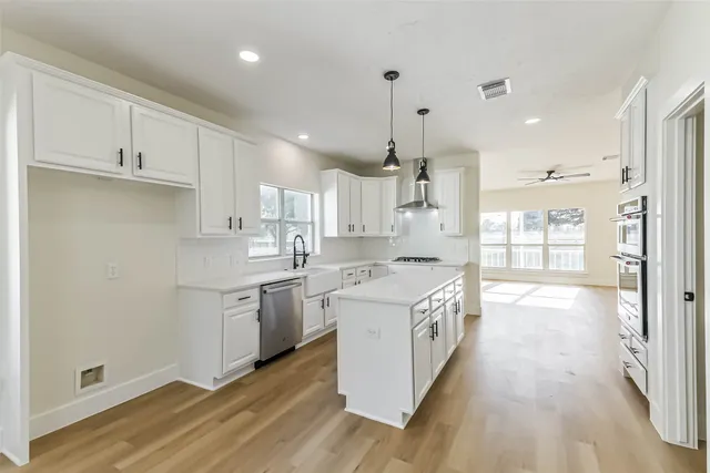 a kitchen with a stove a sink and a refrigerator