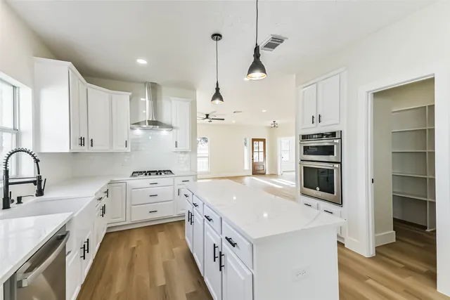 a kitchen with cabinets and stainless steel appliances