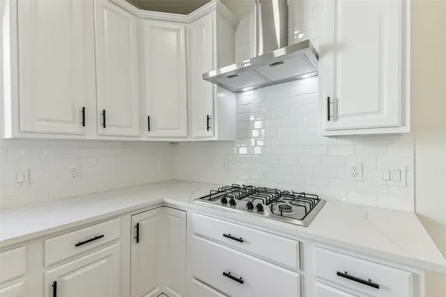 an empty room with windows and cabinet