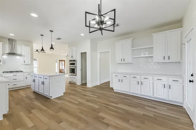 a kitchen with white cabinets