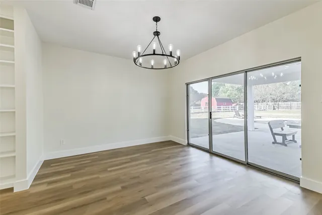 a view of an empty room and wooden floor