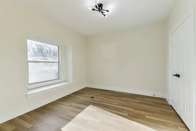 a view of a livingroom with wooden floor and a ceiling fan