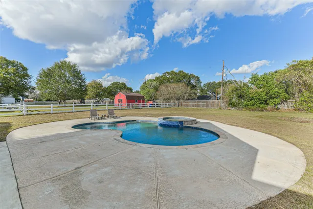 a view of a swimming pool with an outdoor space and seating area