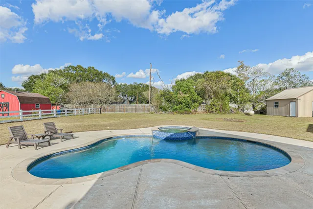 a view of a house with swimming pool and sitting area