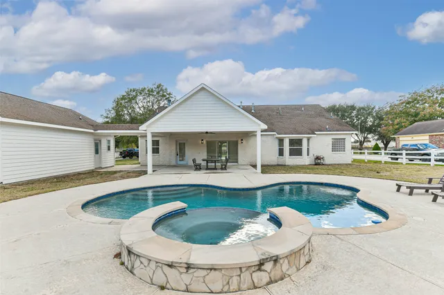 a house with swimming pool in front of it