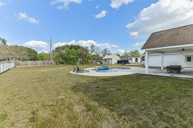 a backyard of a house with table and chairs