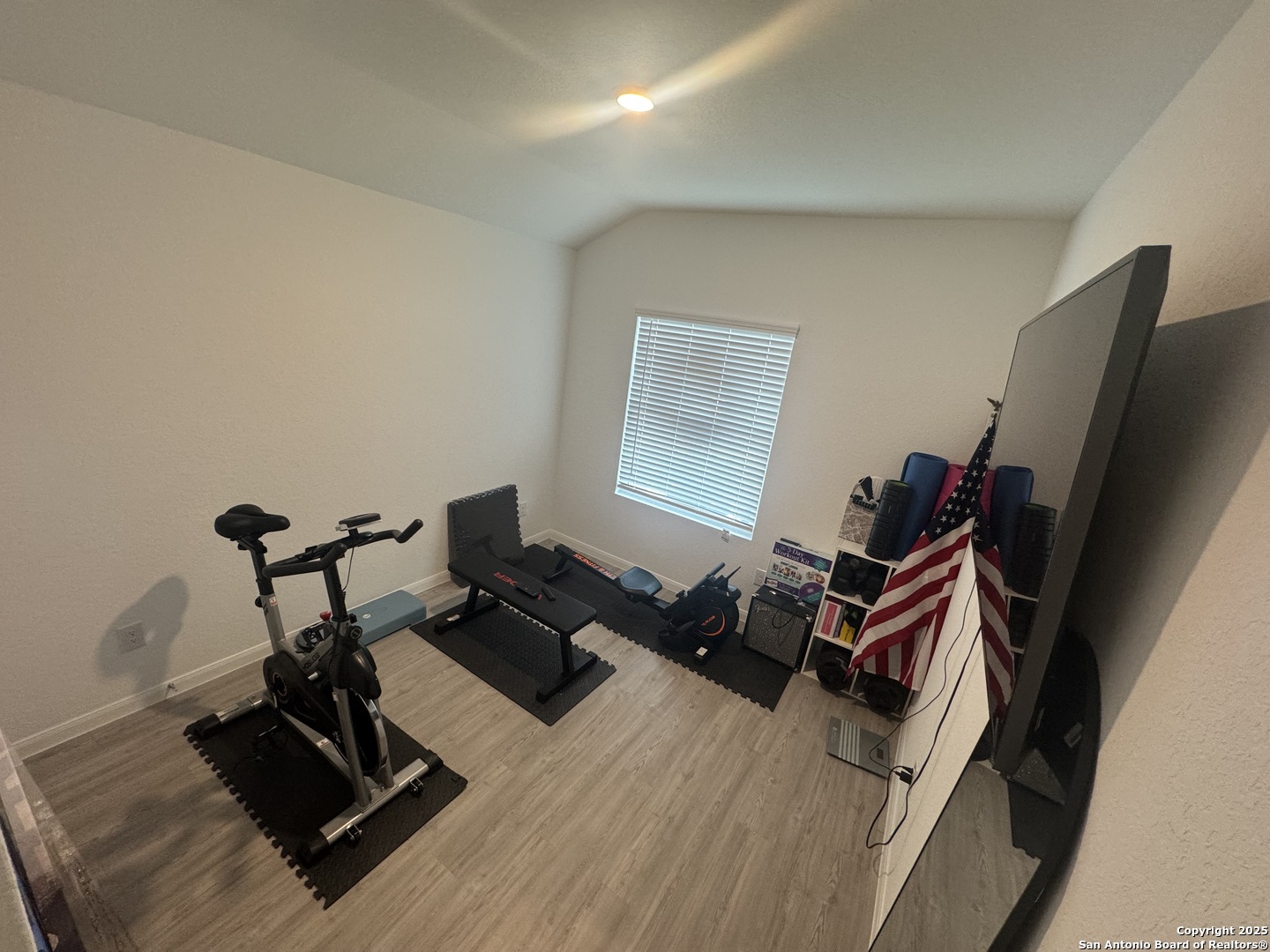 10127 Helios Heights Converse, TX 78109 - Photo 12 of 16 a living room with furniture gym equipment and a flat screen tv