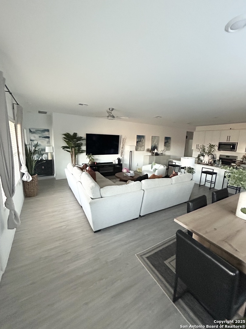 10127 Helios Heights Converse, TX 78109 - Photo 5 of 16 a living room with furniture and a flat screen tv