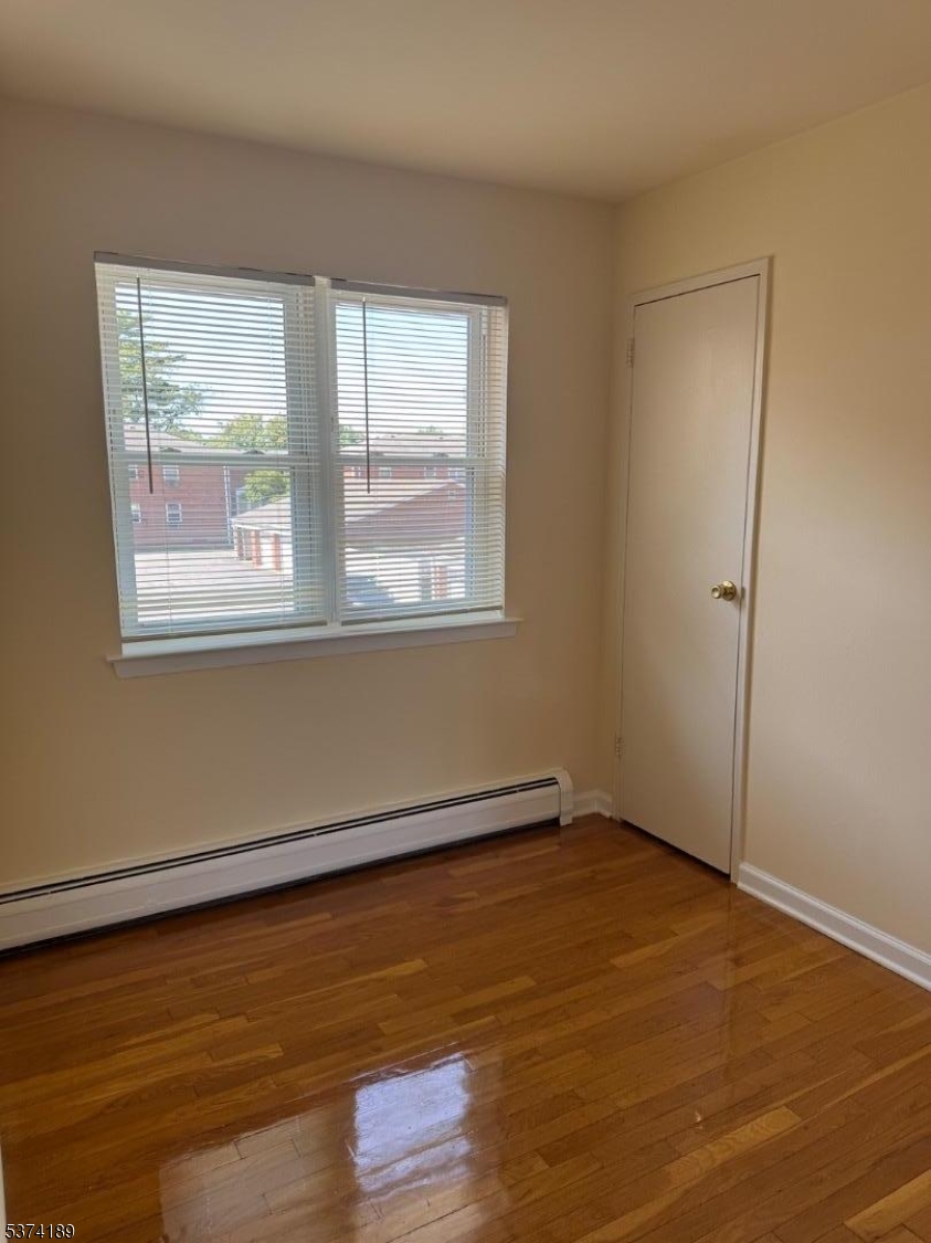 1298 Valley Road, Unit 1 Wayne, NJ 07470 - Photo 12 of 18 an empty room with wooden floor and windows