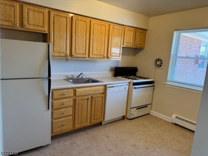 1298 Valley Road, Unit 1 Wayne, NJ 07470 - Photo 15 of 18 a kitchen with cabinets stainless steel appliances and a refrigerator