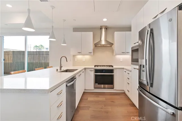a kitchen with stainless steel appliances a refrigerator sink and stove
