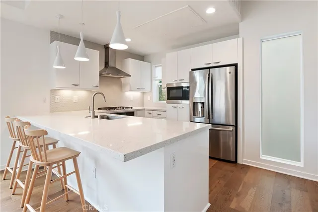 a kitchen with kitchen island a sink stove and refrigerator