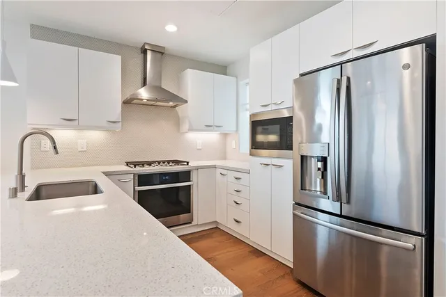 a kitchen with stainless steel appliances a refrigerator stove and sink