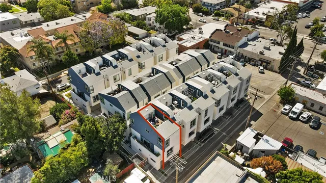 an aerial view of a house with a yard and parking spaces