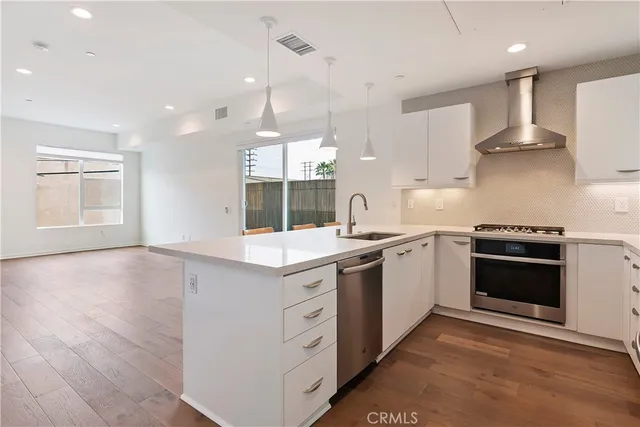 a kitchen with a stove sink and a refrigerator