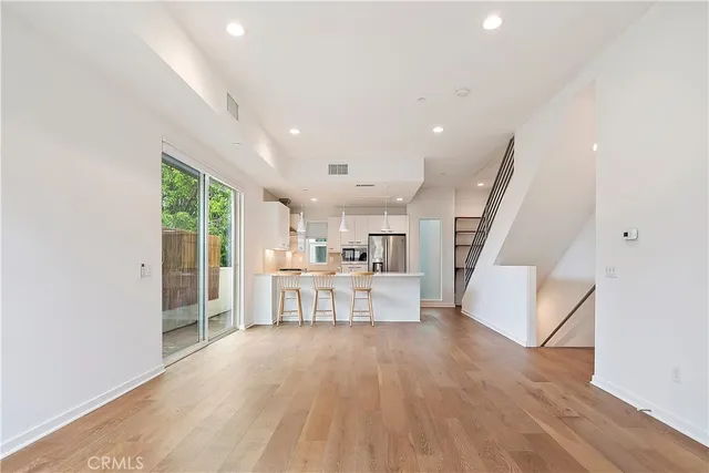 a view of kitchen with furniture and wooden floor