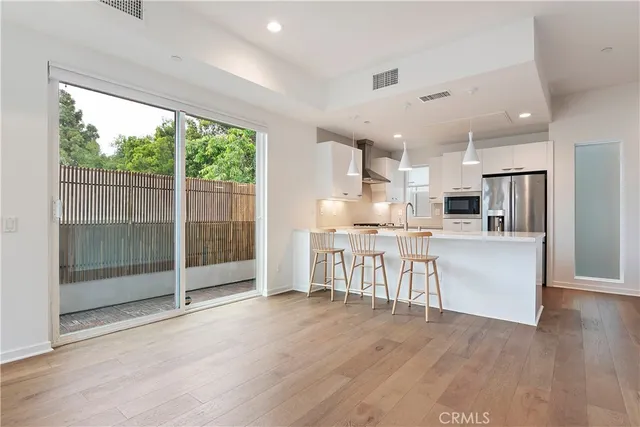 a view of kitchen with furniture and refrigerator