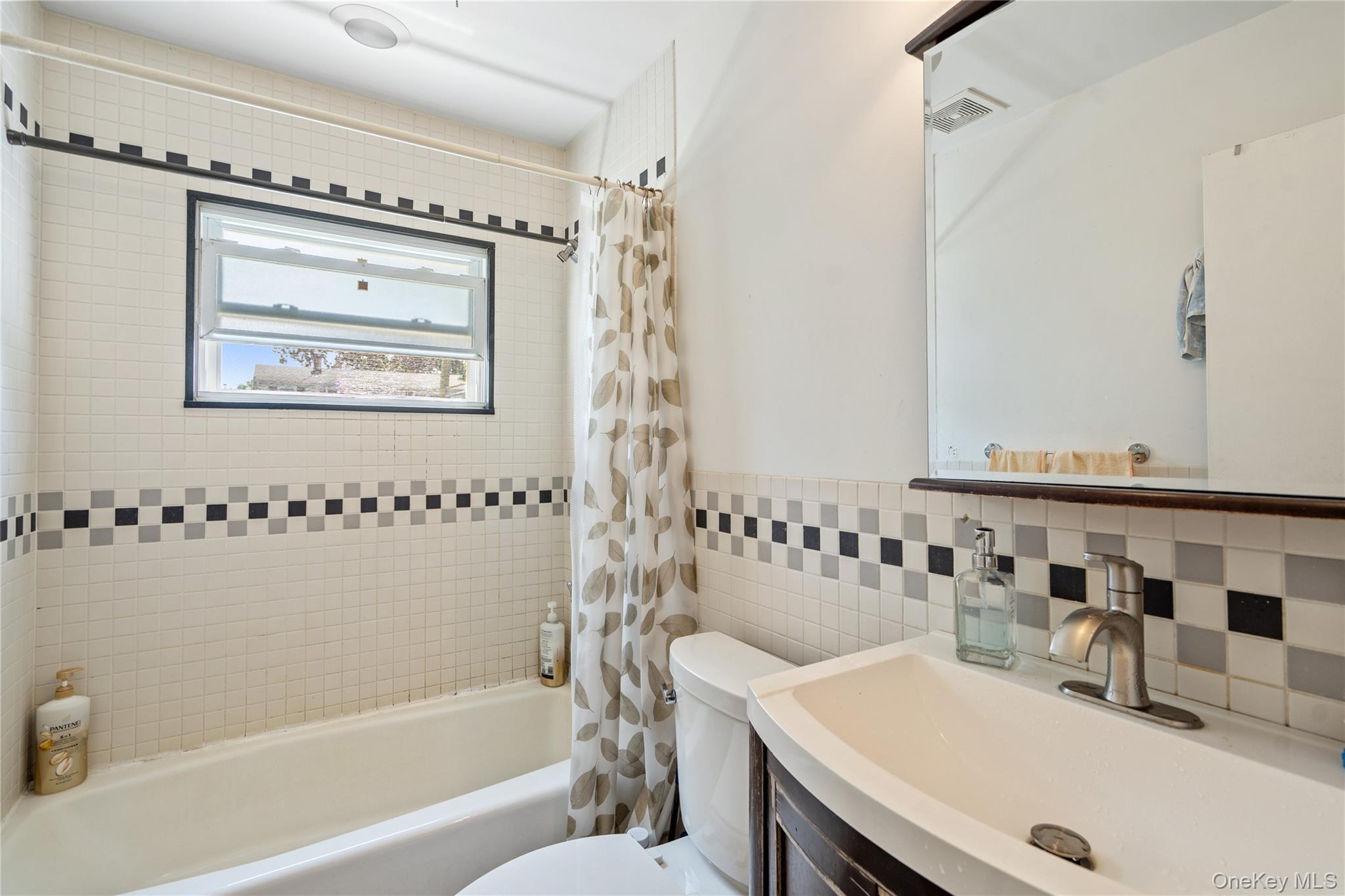 9 Rugby Road Massapequa, NY 11758 - Photo 11 of 33 a bathroom with a sink and a mirror