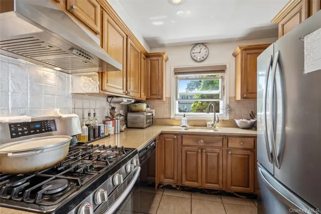 a kitchen with a stove a sink and a refrigerator
