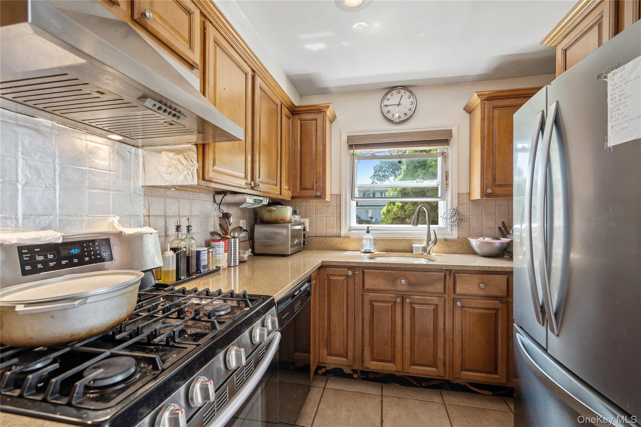 9 Rugby Road Massapequa, NY 11758 - Photo 12 of 33 a kitchen with a stove a sink and a refrigerator