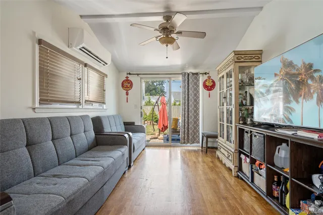 a living room with furniture a ceiling fan and a rug