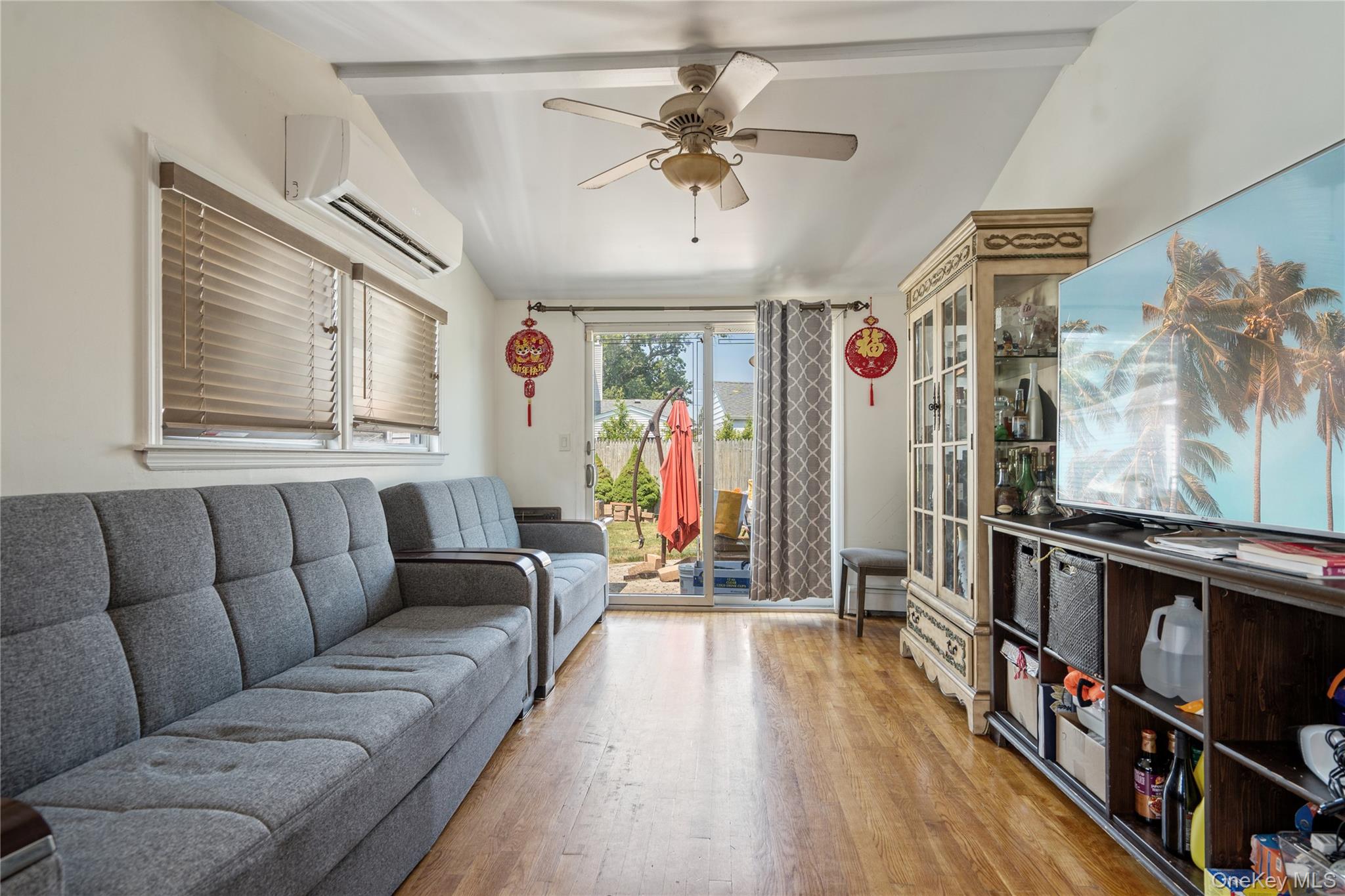 9 Rugby Road Massapequa, NY 11758 - Photo 14 of 33 a living room with furniture a ceiling fan and a rug