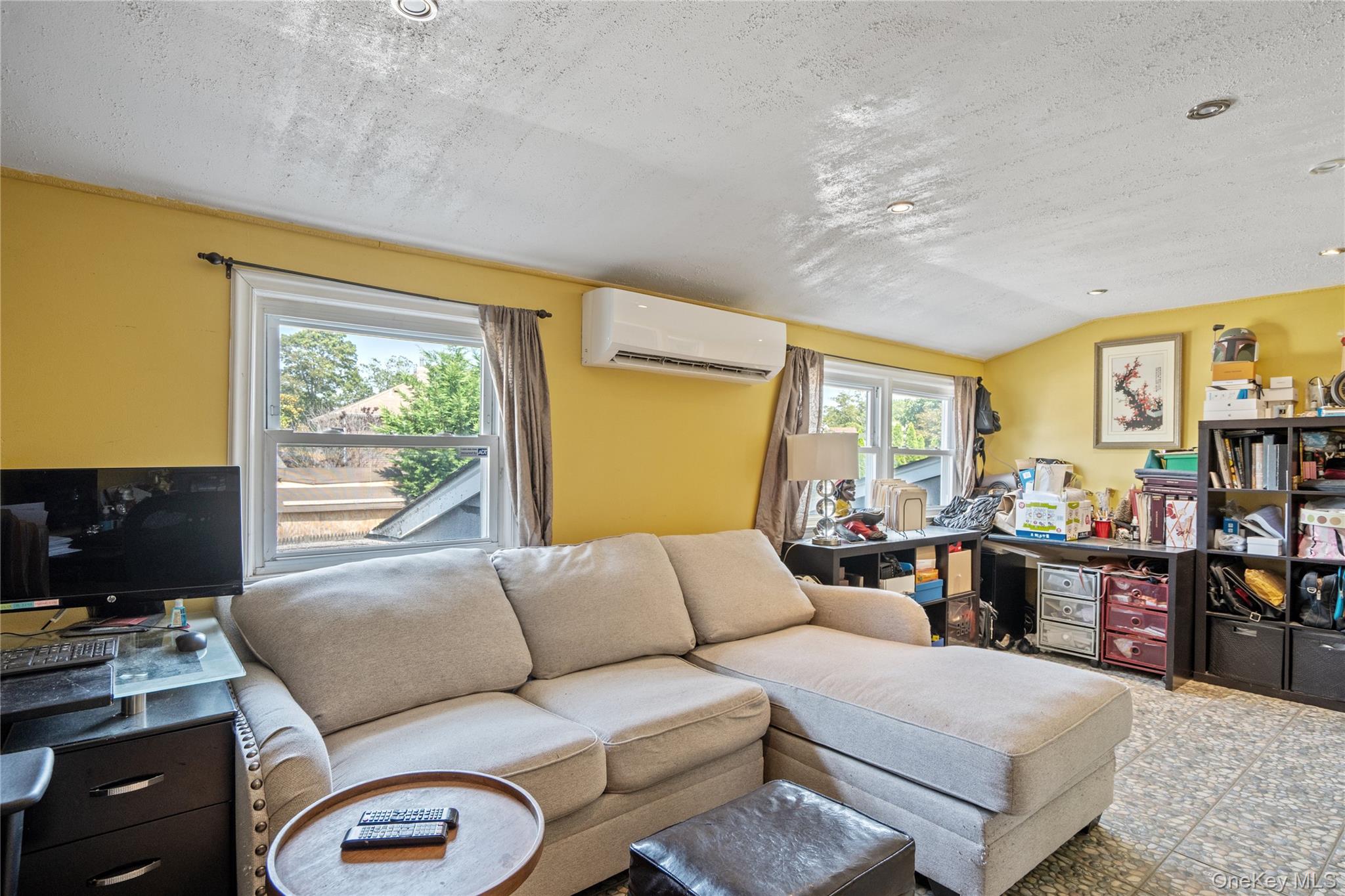 9 Rugby Road Massapequa, NY 11758 - Photo 17 of 33 a living room with furniture a flat screen tv and a window