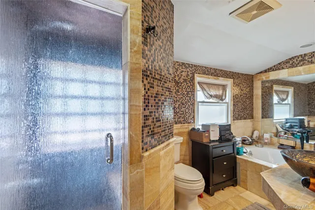 a bathroom with a toilet a sink and a shower