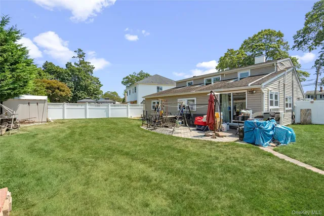 a view of a house with a backyard and a patio
